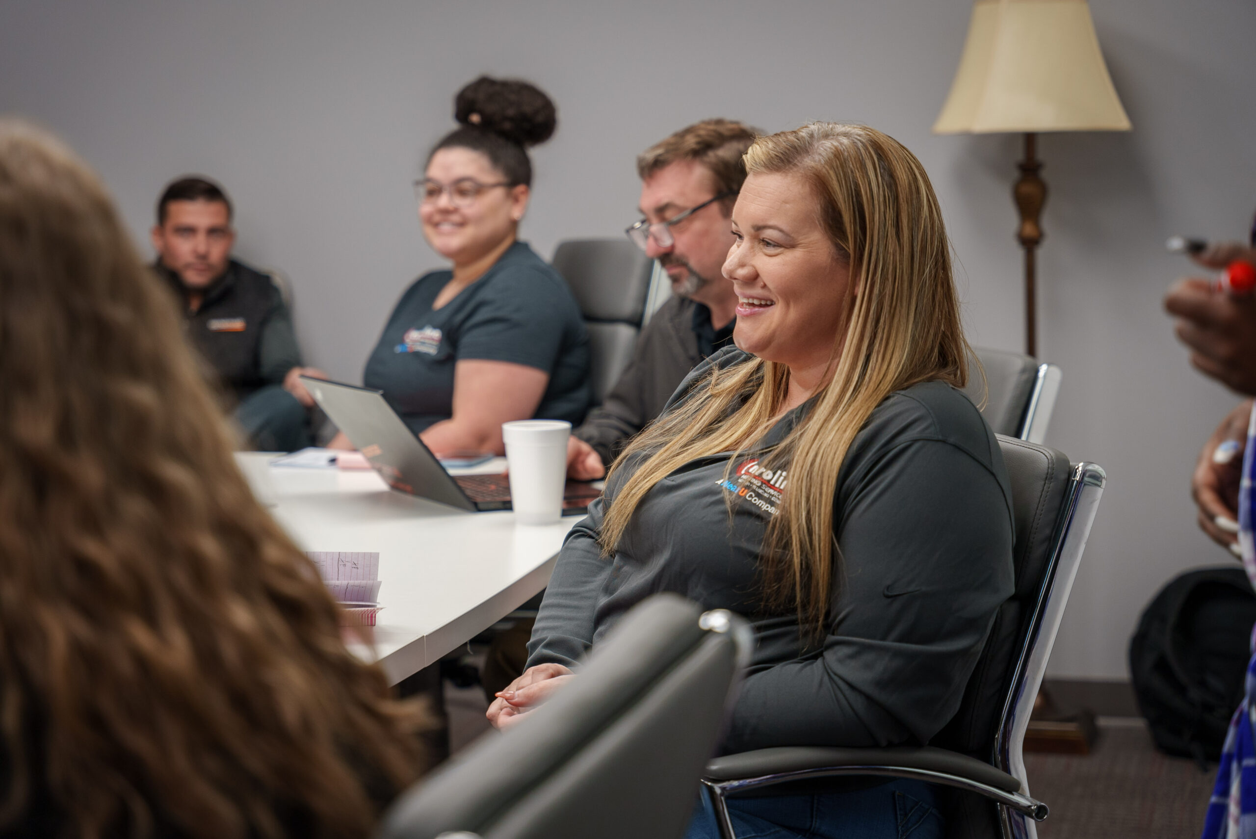 030624-CHS-3 - Carolina Heating Service Inc. Employees smiling and sitting around a table