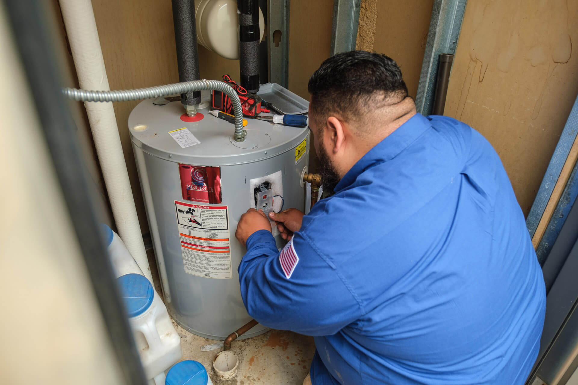 A Carolina Heating Service technician servicing a water heater - Carolina Heating Service Inc. A Carolina Heating Service technician servicing a water heater