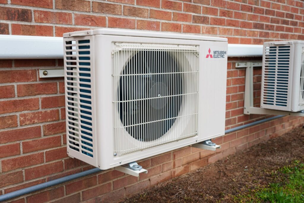 A Mitsubishi Electric Heat Pump installed on the exterior of a building
