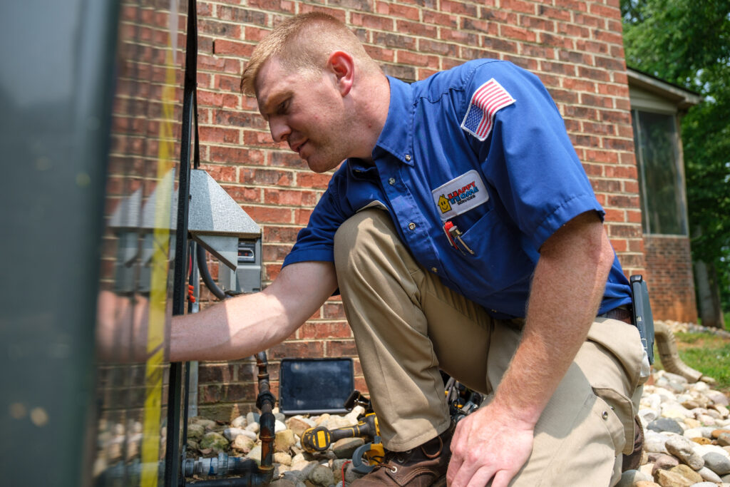 Privacy Policy - Carolina Heating Service Inc. Happy Home tech preparing an air conditioning unit for the winter in Durham NC