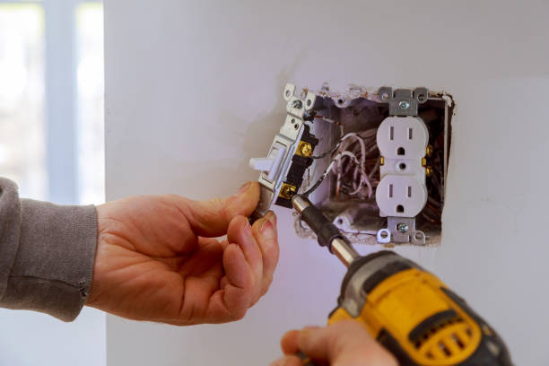 A licensed electrician performing a switch replacement in Greenville, SC