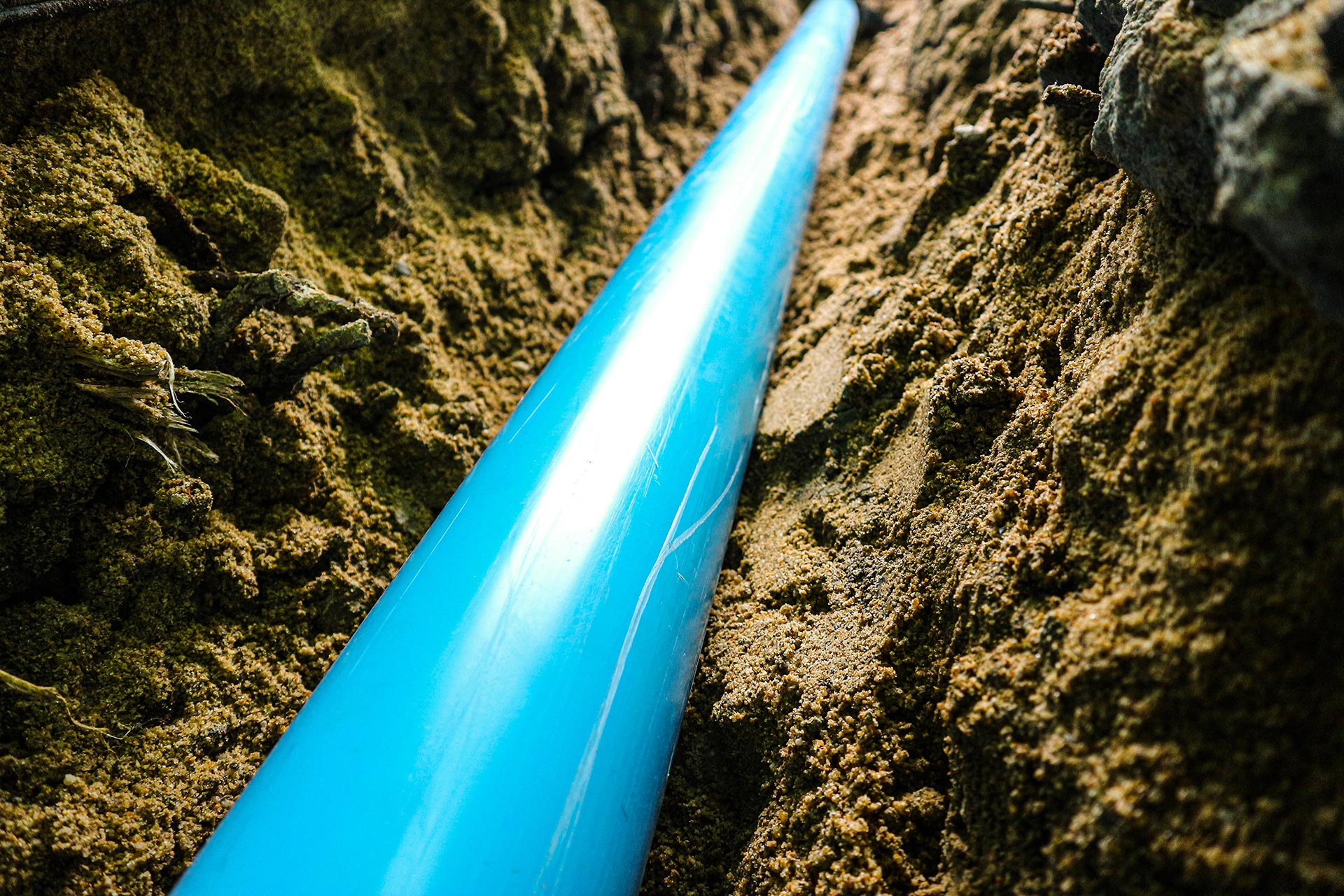 Photo-of-a-blue-sewer-line-in-dirt - Carolina Heating Service Inc. Photo-of-a-blue-sewer-line-in-dirt