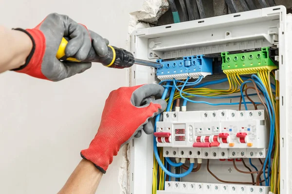 An electrician performing rewiring services at a home in Greenville, SC